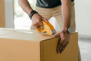 Man packing boxes for his event company