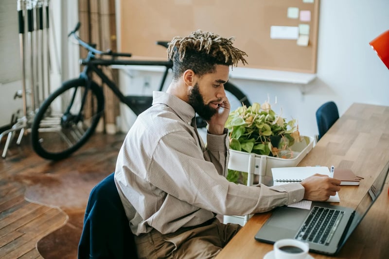  Businessman on phone discussing office space for lease at his desk | U Can Store