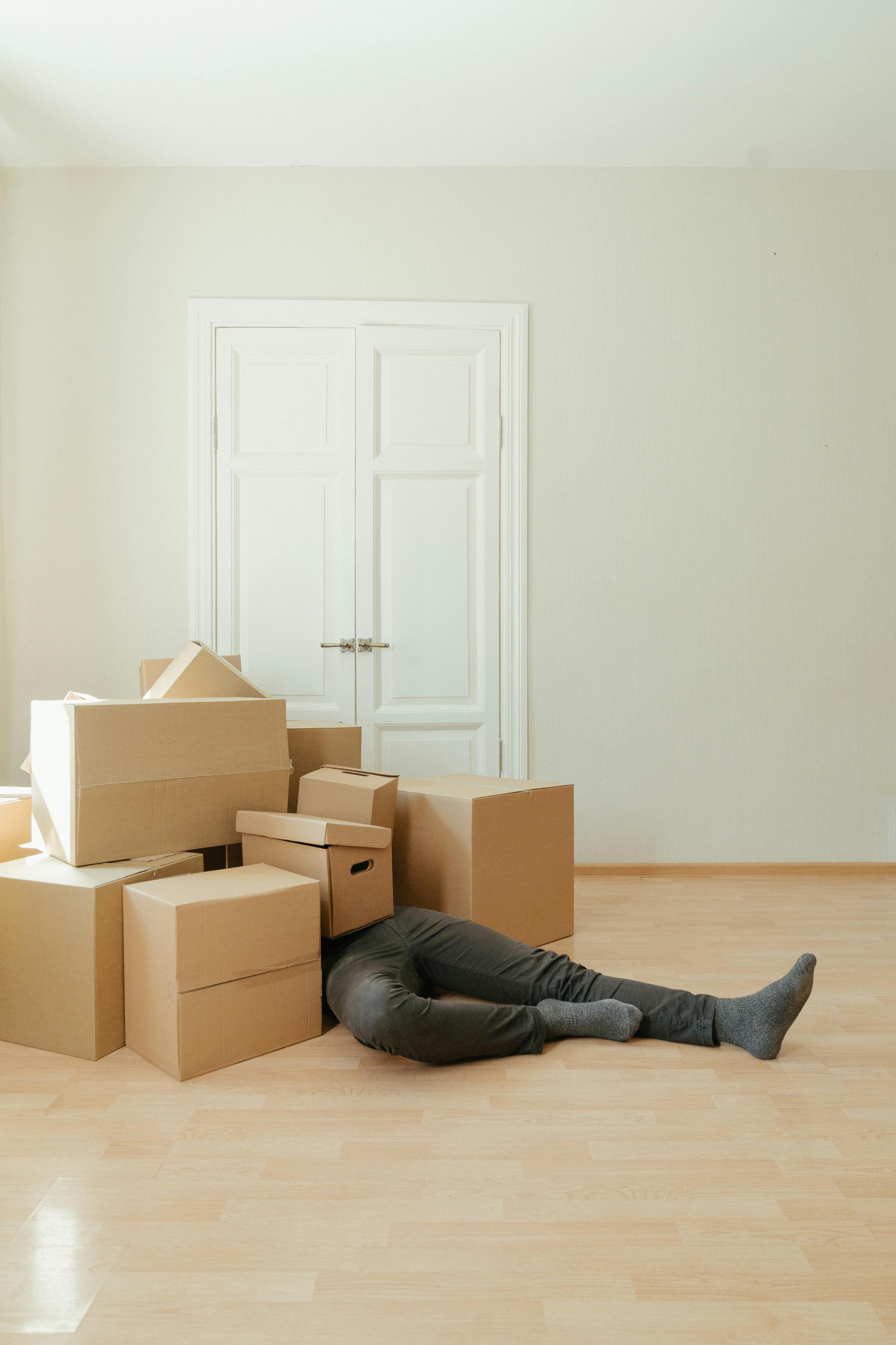 Man struggling with cluttered boxes, highlighting the convenience of using U Can Store for personal storage needs.