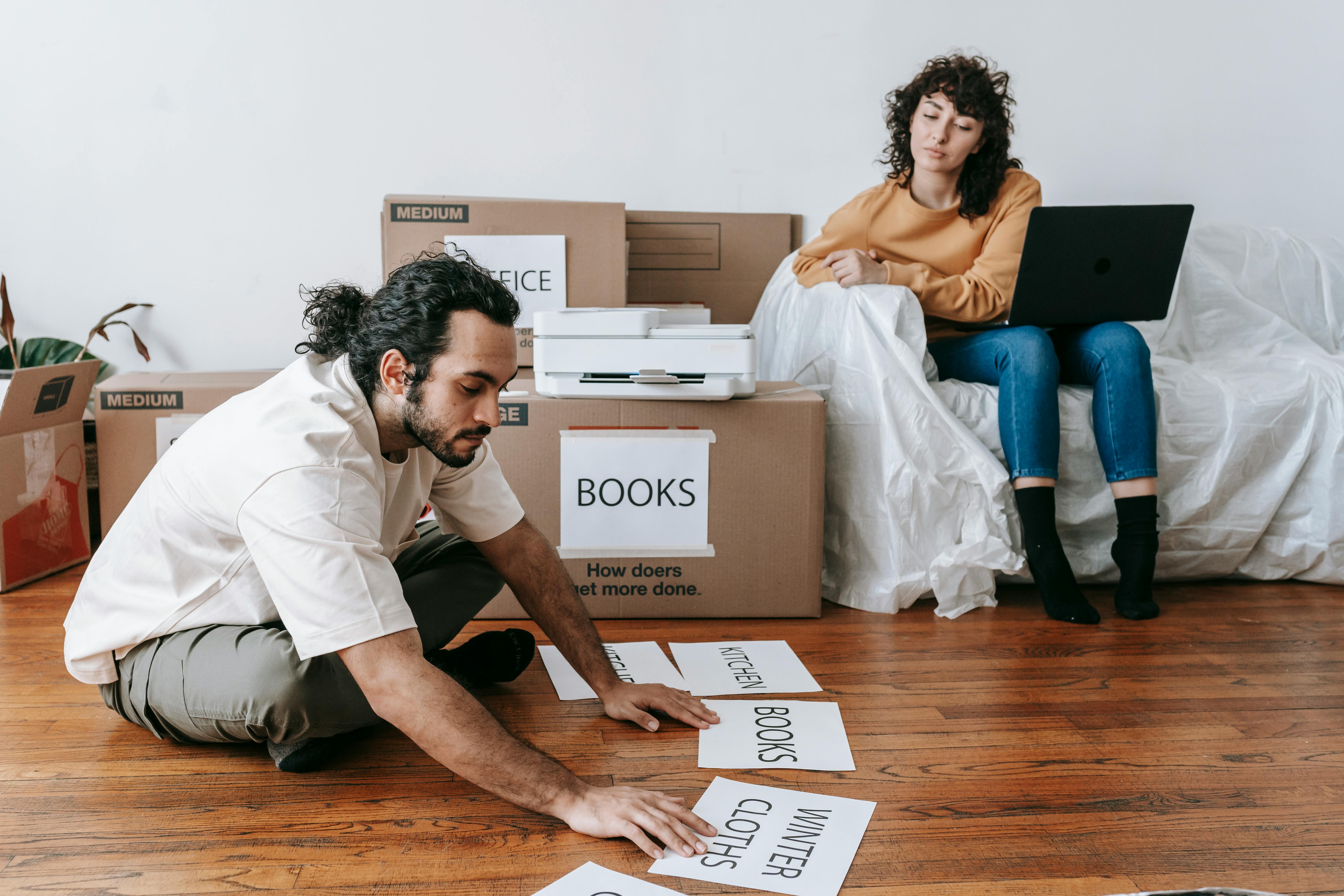 Couple packing storage boxes